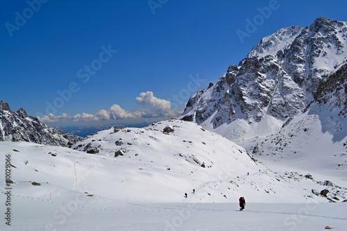 Hiking trail in snow in mountains in a sunny day