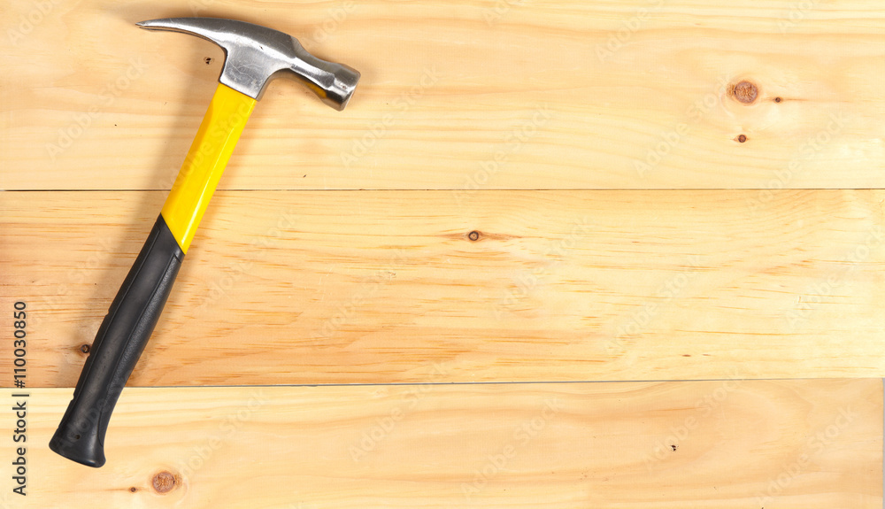 Hammer wrench on wooden background