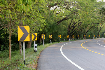 The road curve with street signs reflex light.