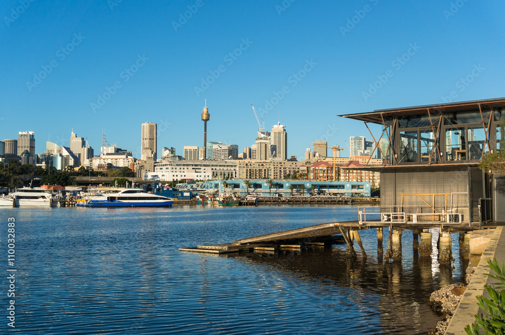 Sydney city view of boat house, Sydney Fish Market, Glebe and CBD with Sydney Tower Centrepoint as viewed from Blackwattle bay. Office, commercial and residential skyscraper buildings