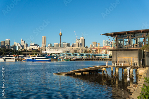 Sydney city view of boat house, Sydney Fish Market, Glebe and CBD with Sydney Tower Centrepoint as viewed from Blackwattle bay. Office, commercial and residential skyscraper buildings photo