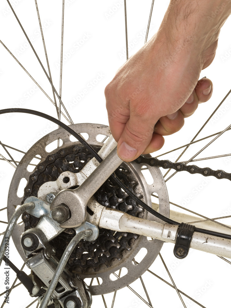 Fototapeta premium Man repairing rear wheel on a bicycle