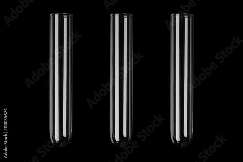 Three glass transparent test tubes on black background