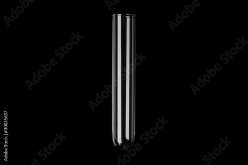 Glass transparent test tube on black background