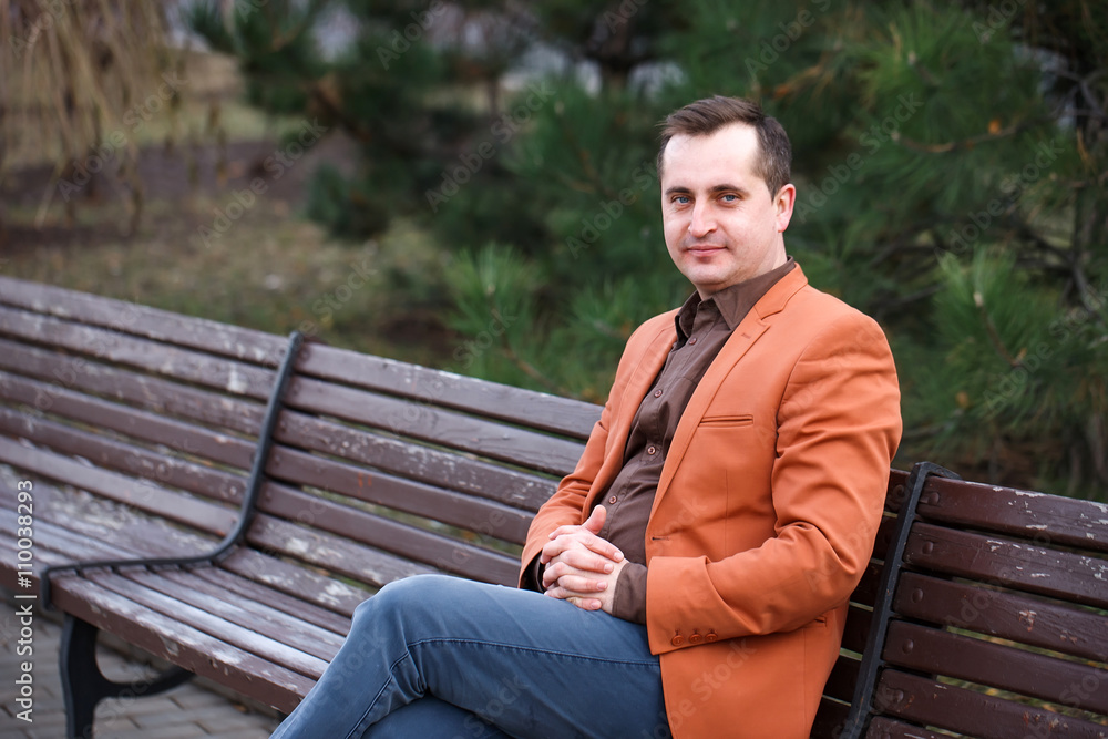 40+ man with a problem of baldness is sitting on the bench.