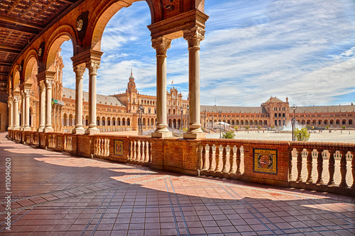 The famous Square of Spain, in Spanish Plaza de Espana, view from the path with columns, one example of the mixing Regionalism Architecture Renaissance and Moorish styles. Seville, Andalucia, Spain. photo