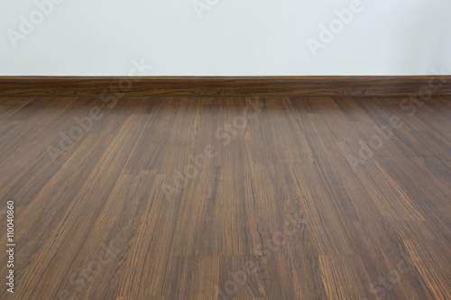 empty room, white mortar wall background and wood laminate floor © sutichak