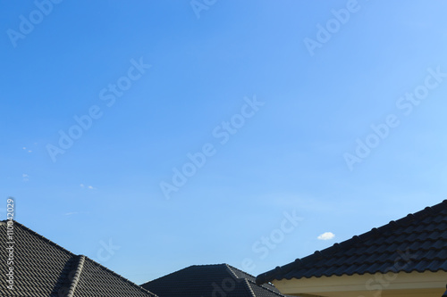 black tile roof on a new house with clear blue sky background