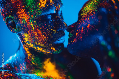 People are colored fluorescent powder. a pair of lovers dancing photo