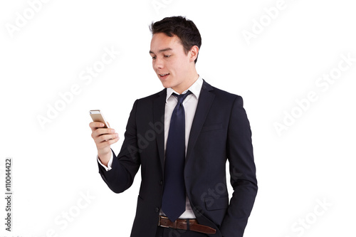 Young Caucasian business man looking at mobile phone smiling