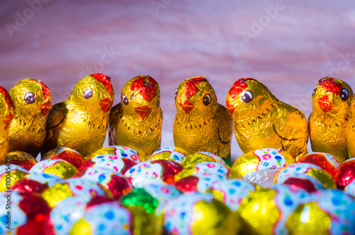 Easter chocolate little eggs andchicks covered in multicolor paper