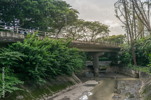 Canvas Print View of city bridge, water drainage and forest in Singapore city, color filtered