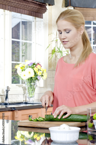 a woman slicing bitter melon