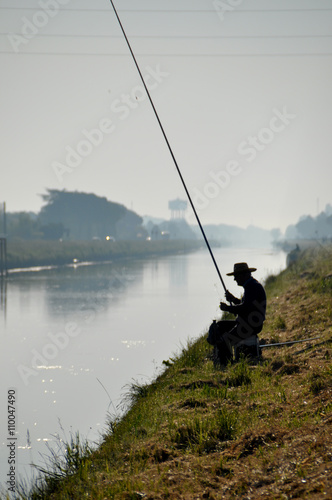 Fishing man in morning mist