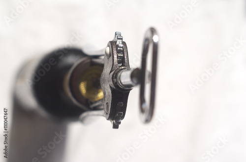 A bottle of wine and a sommelier corkscrew