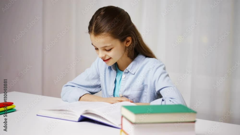 happy school girl reading book or textbook at home happy school girl reading book or textbook at home