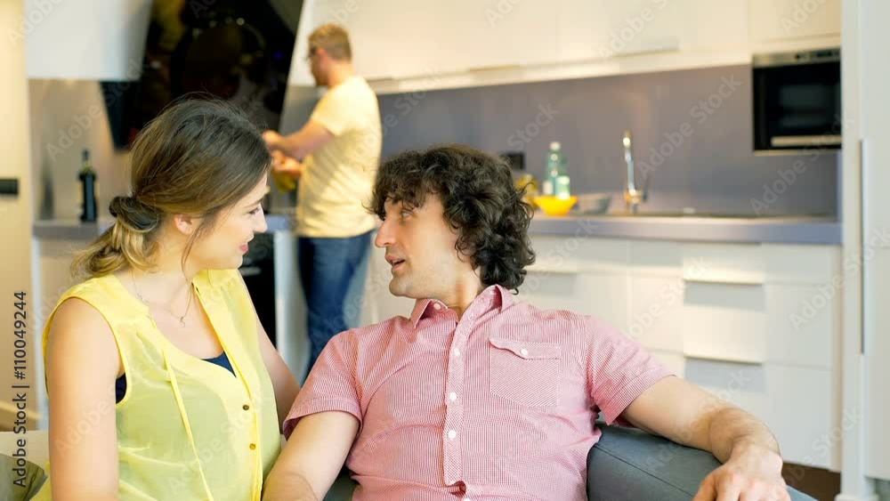 Couple chatting on the sofa and their friend showing them thumbs up
Couple chatting on the sofa and their friend showing them thumbs up
