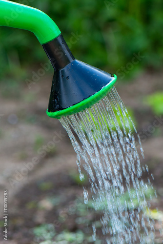 Watering can with water drops