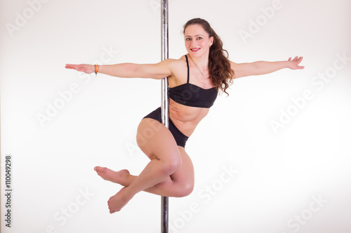 Sexy pole dancer on white studio background