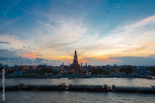 River and Wat Arun Temple during the sunset in Bangkok Thailand