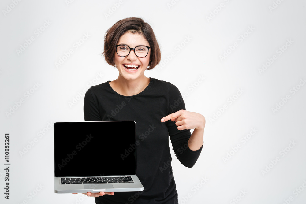 Woman pointing finger on blank laptop computer screen Woman pointing finger on blank laptop computer screen
