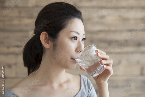 Women are drinking a glass of water