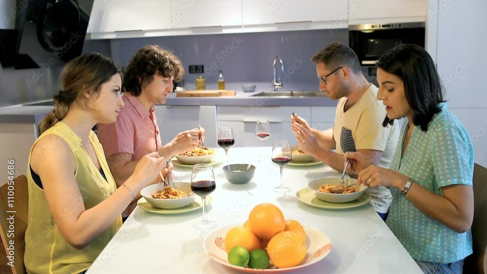 Friends chatting with each other while eating the dinner
Friends chatting with each other while eating the dinner