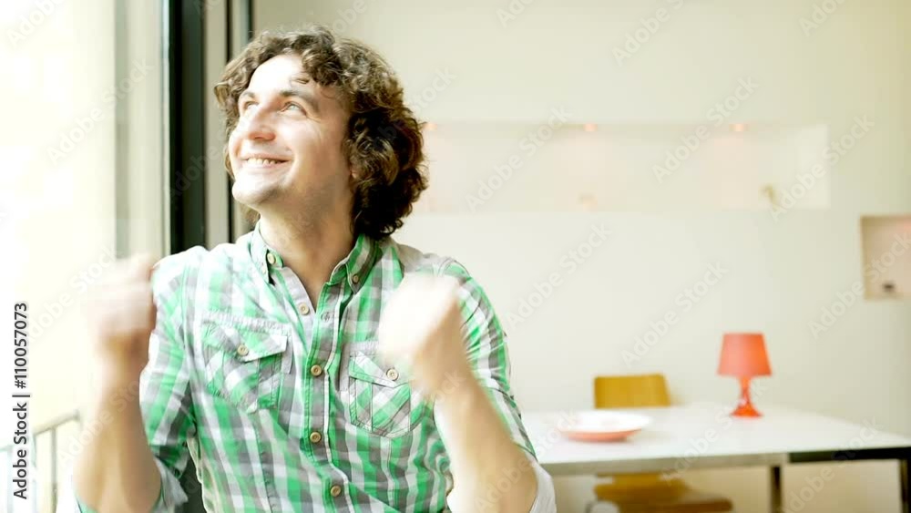 Joyful man standing next to the window and thinking, steadycam shot
Joyful man standing next to the window and thinking, steadycam shot