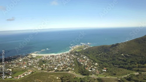 Cape Town city 4K UHD aerial footage of Camps Bay & Lions Head mountain peak.