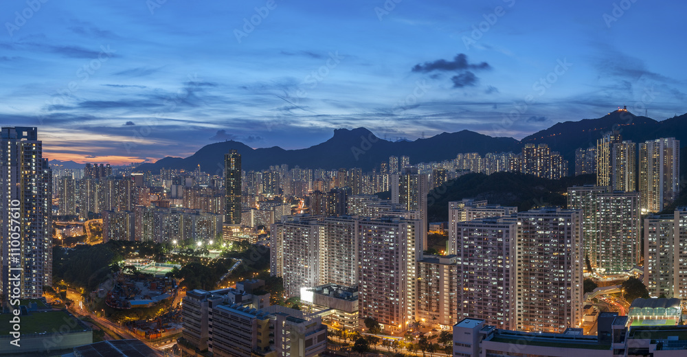 Panorama of Hong Kong City skyline and Lion Rock Hill at dusk