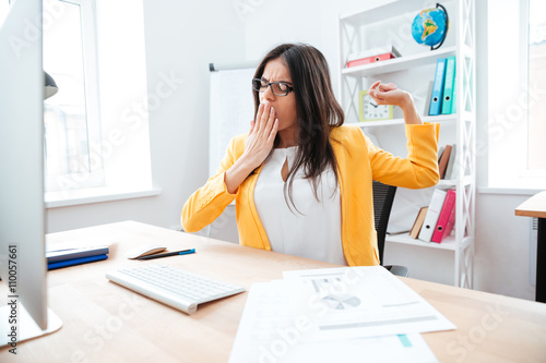 Businesswoman yawning in office