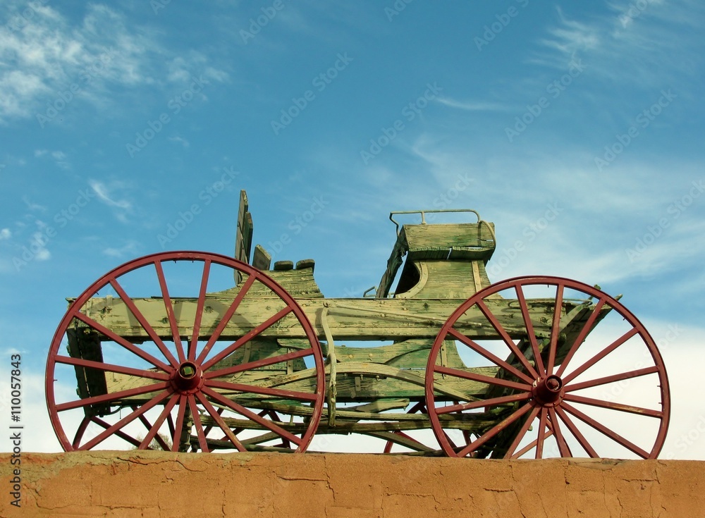 Wooden waggon on the roof against blue sky