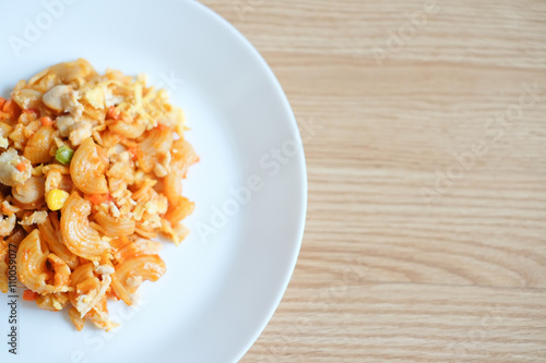 macaroni pasta in tomato sauce on a wooden table