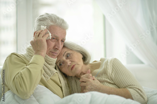  sick elderly couple in bed