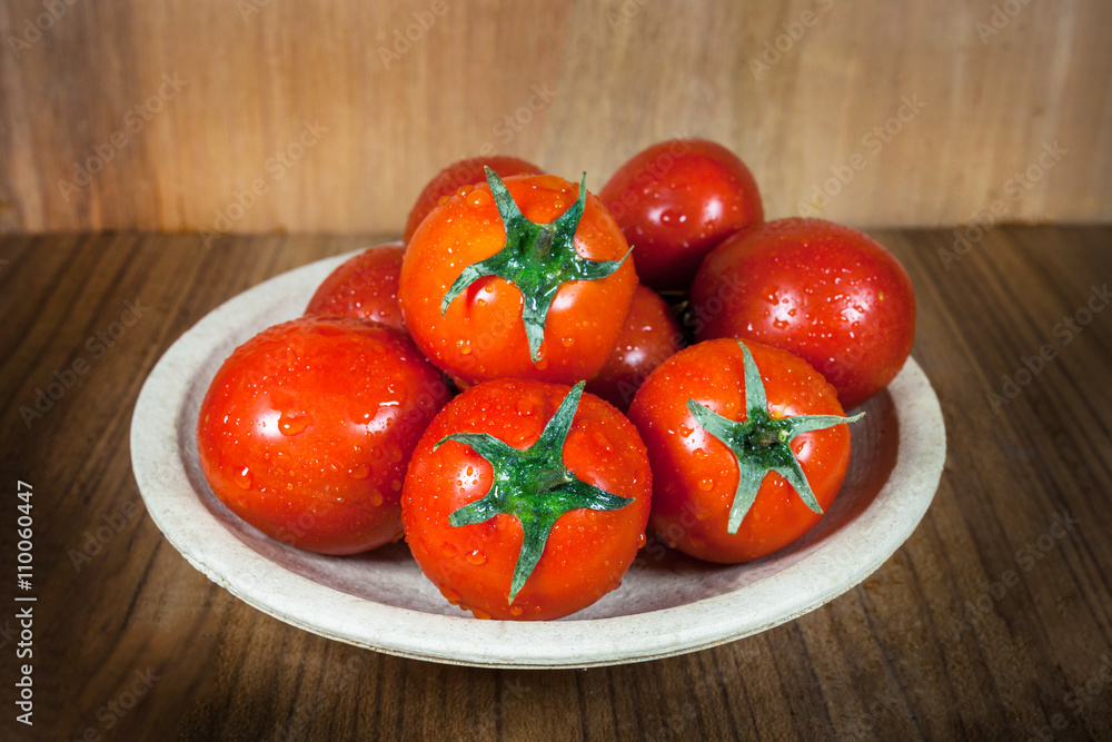Close-up fresh ripe tomatoes on wood background Close-up fresh ripe tomatoes on wood background