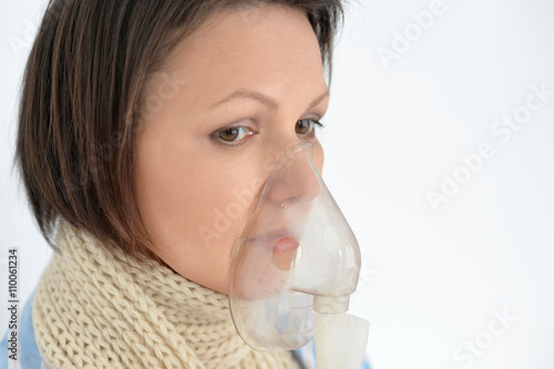 Sick brunette woman with inhaler