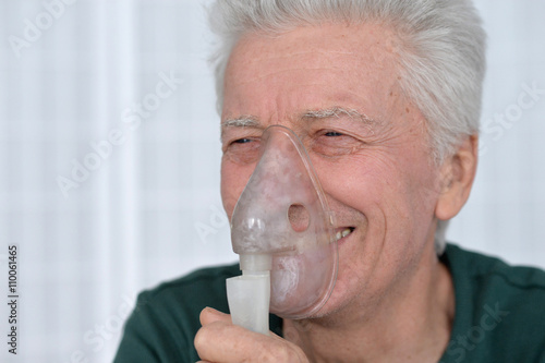 Joyful Senior man with inhaler