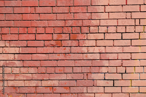 Red brick wall as background front view closeup