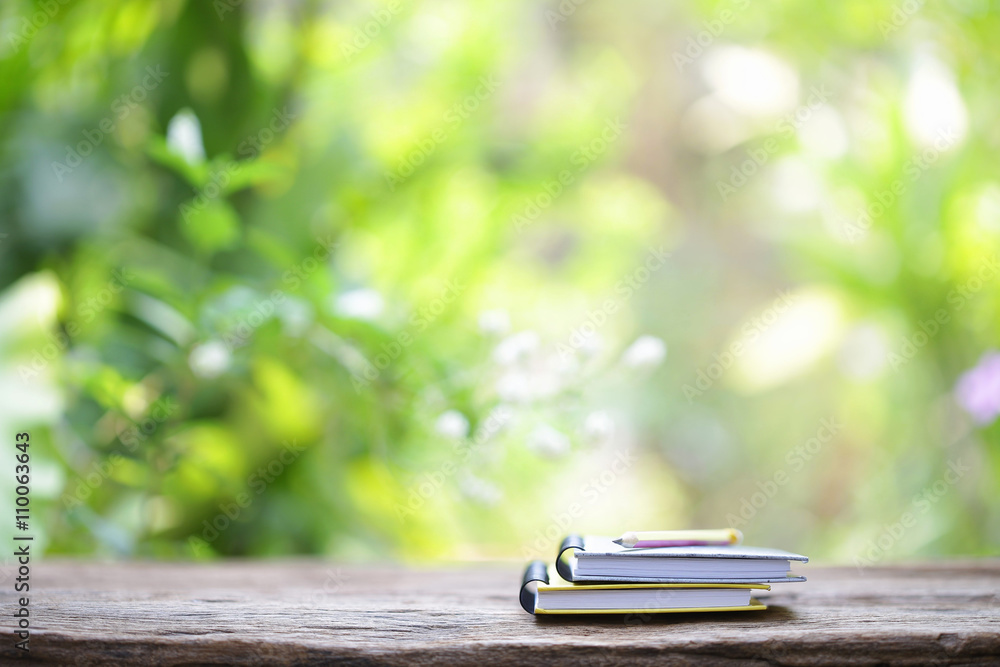 Notebook and pencil on wooden table