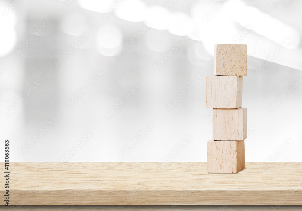 Four wooden cubes on table over blur abtract bokeh background Four wooden cubes on table over blur abtract bokeh background