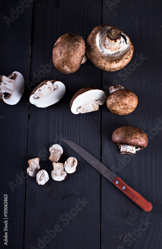 Fresh mushrooms on a black board. Champignon mushrooms