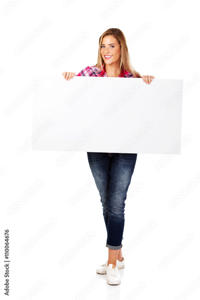 Young smiling woman holding empty banner Young smiling woman holding empty banner