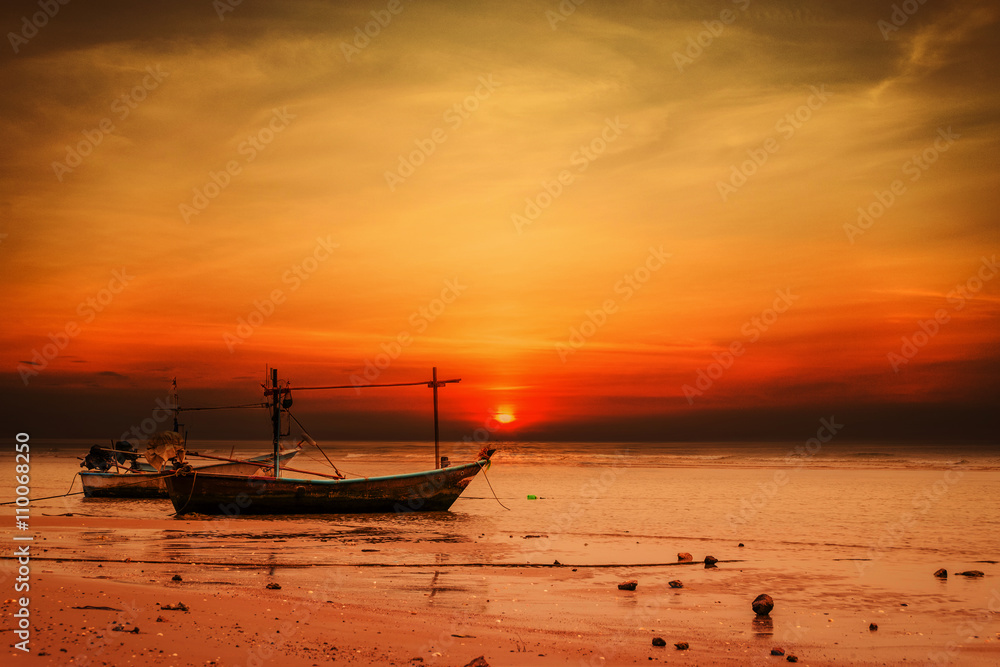 Small boat at the Andaman Sea at sunset
