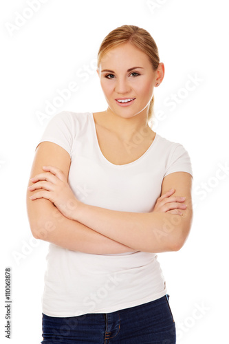 Happy young woman wiyh folded arms