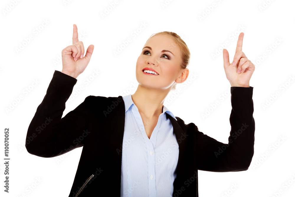 Young smiling business woman pointing up Young smiling business woman pointing up