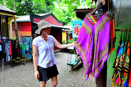 Woman shopping at the Original Rainforest  Market in Kuranda Que photo