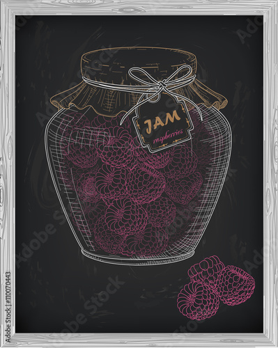 beautiful jar of homemade jam with raspberry on a black backgrou