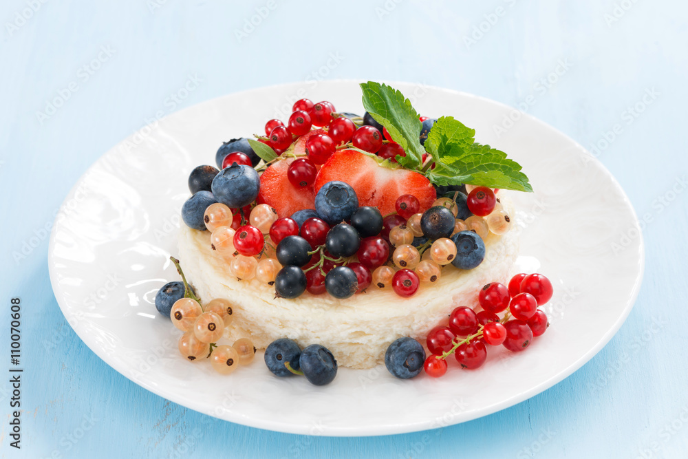 mini cheesecake with fresh berries on a blue background mini cheesecake with fresh berries on a blue background