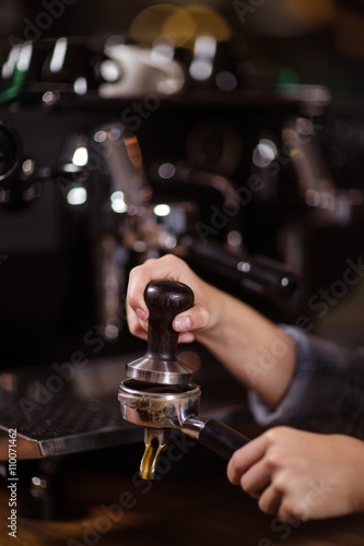 Close up of barista preparing coffee with machine