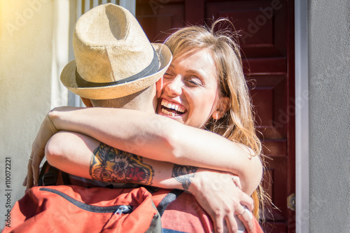 Couple of lovers hugging - He is just come back at home after a long trip - Portrait of two caucasian lovers photo